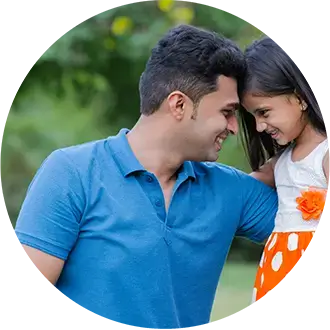 A father and his young daughter smiling as they lean their heads together.